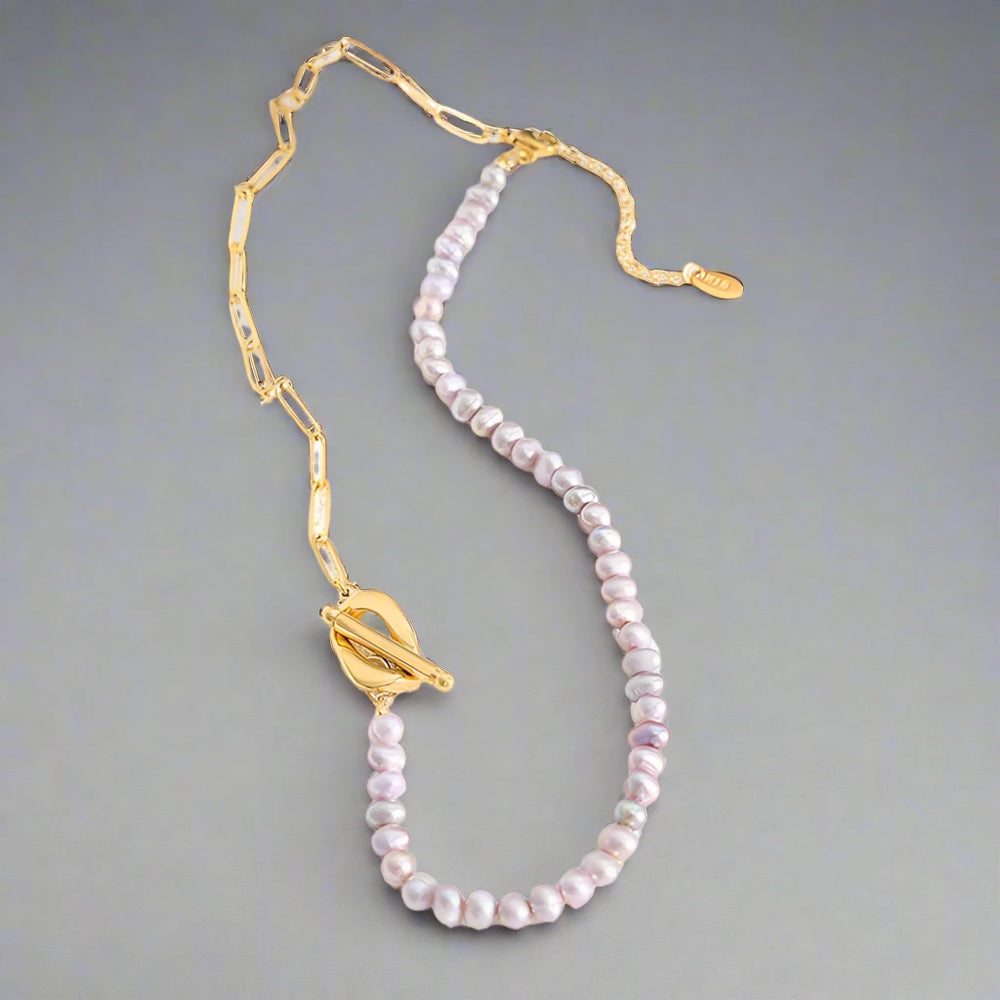 Paperclip and Pearl T Bar necklace in Gold with simulated freshwater pearls in a soft pink colour.