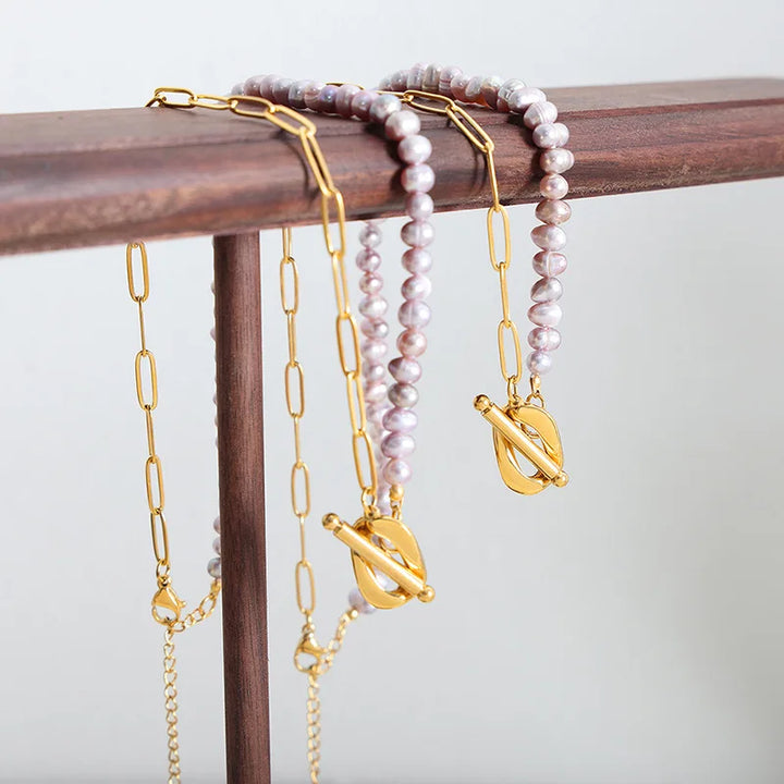 Paperclip and Pearl T Bar necklace in Gold with simulated freshwater pearls in a soft pink colour.