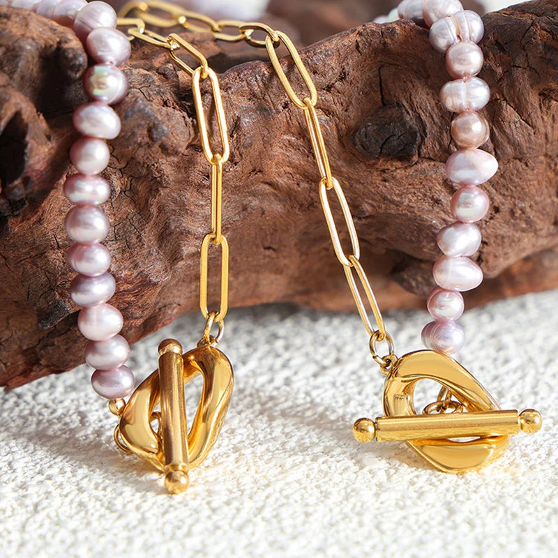 Paperclip and Pearl T Bar necklace in Gold with simulated freshwater pearls in a soft pink colour.