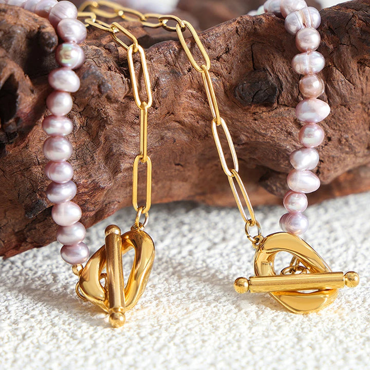 Paperclip and Pearl T Bar necklace in Gold with simulated freshwater pearls in a soft pink colour.