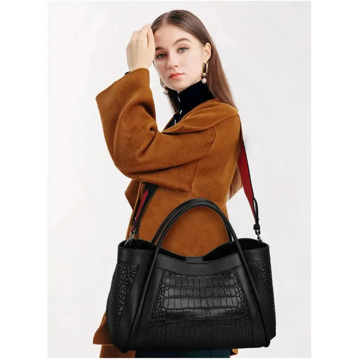 The Megyn Tote Bag in Black is an East/West style featuring rolled top grab handles and seamed detail.