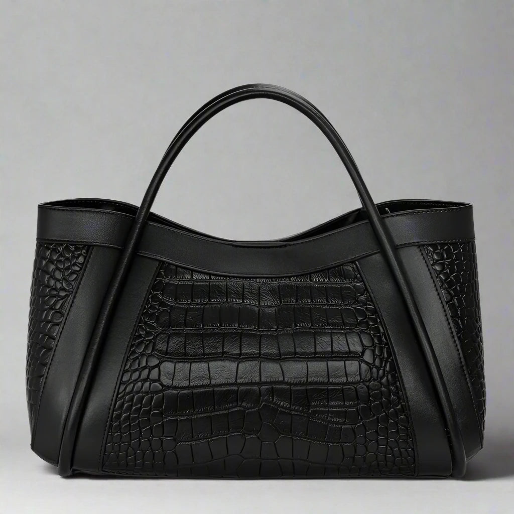 The Megyn Tote Bag is an East/West style featuring rolled top grab handles and seamed detail.