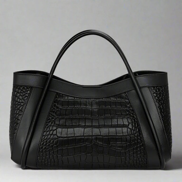 The Megyn Tote Bag is an East/West style featuring rolled top grab handles and seamed detail.