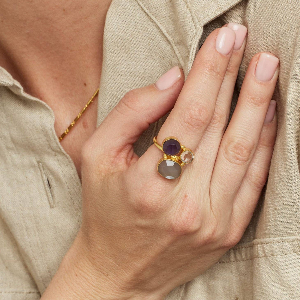 A close up of a model's hand wearing the Tillie Multistone Adjustable Gold Ring