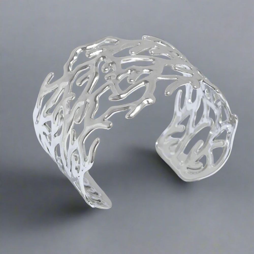 Adjustable women's wide cuff bracelet in a coral design. Silver