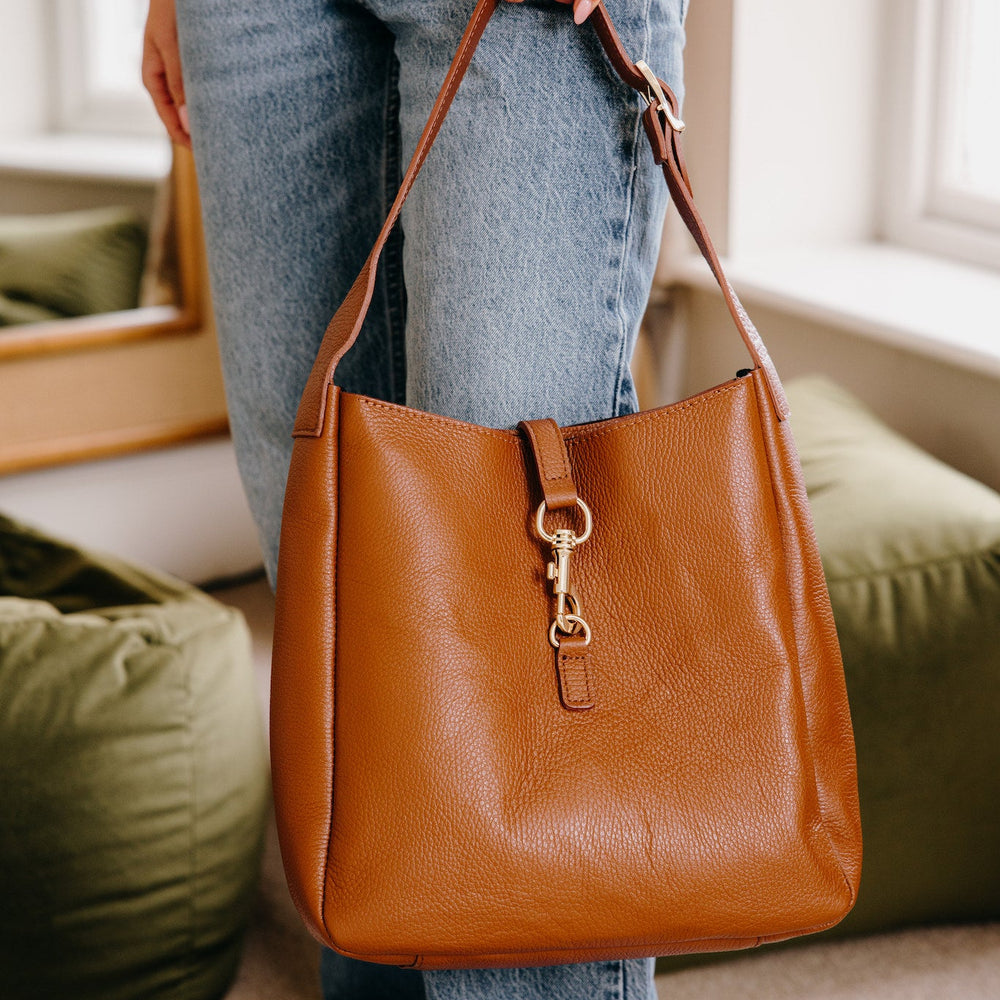 Tan leather hobo shoulder bag with hold hardware