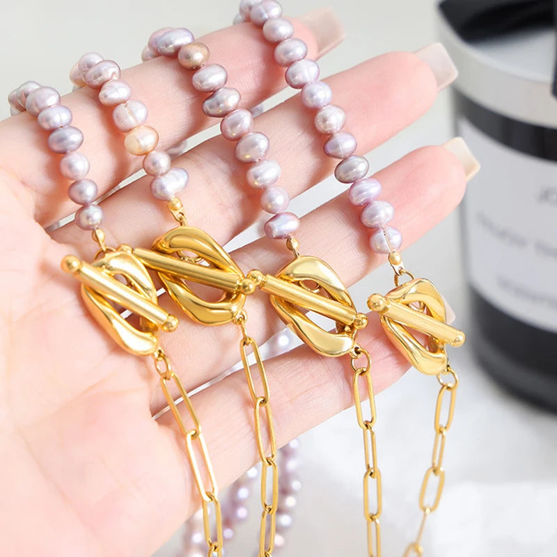 Paperclip and Pearl T Bar necklace in Gold with simulated freshwater pearls in a soft pink colour.