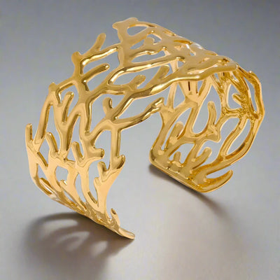 Adjustable women's wide cuff bracelet in a coral design. Gold