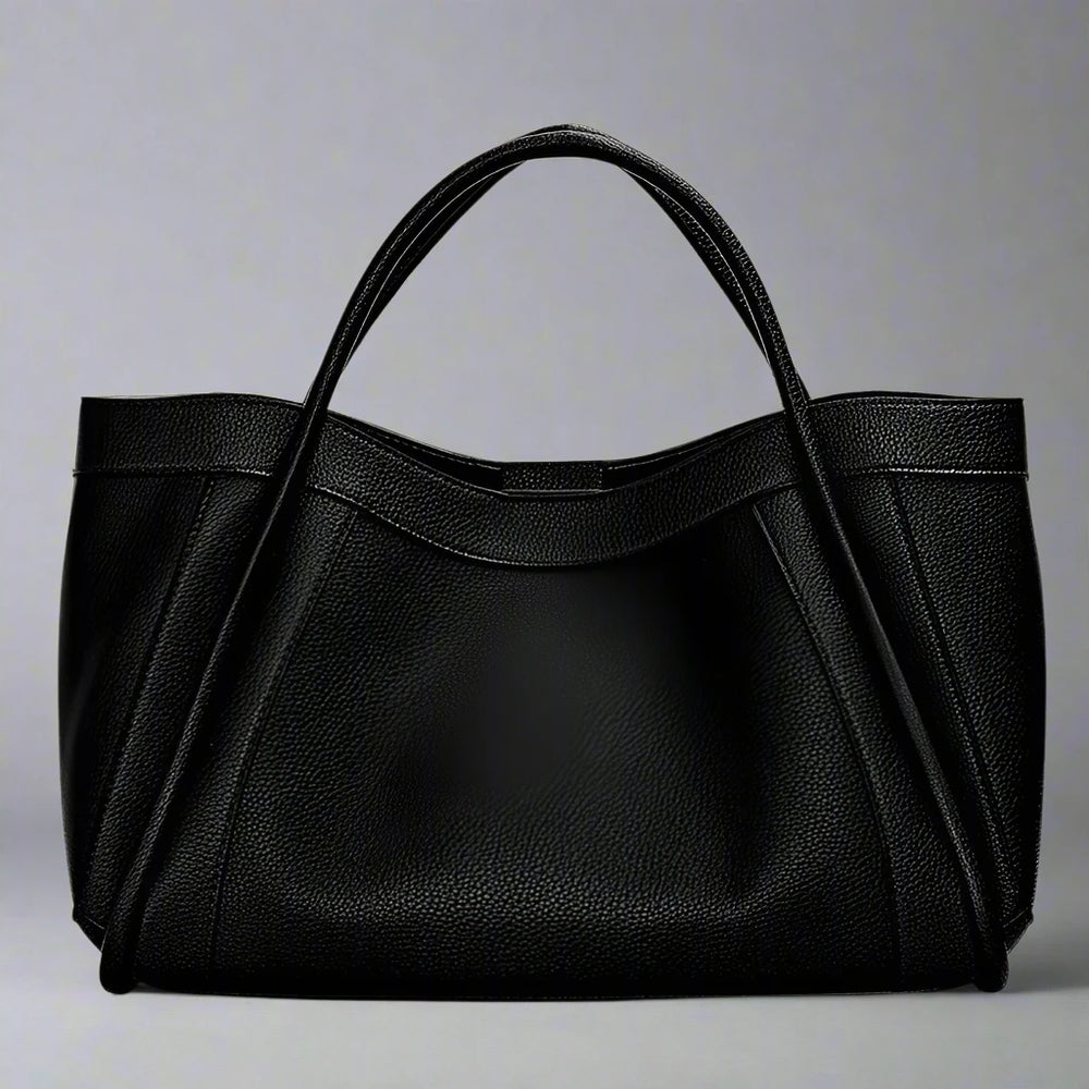 The Megyn Tote Bag is an East/West style featuring rolled top grab handles and seamed detail.
