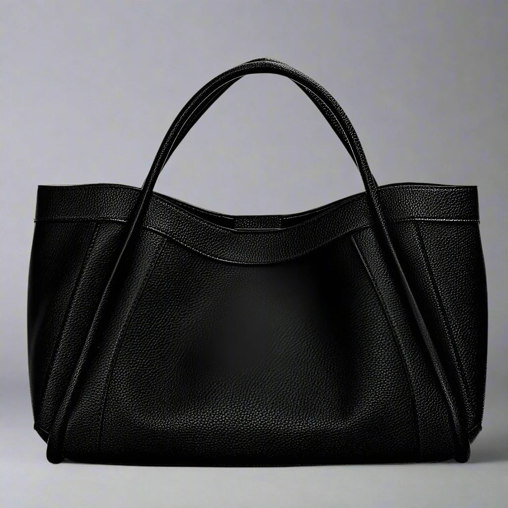 The Megyn Tote Bag is an East/West style featuring rolled top grab handles and seamed detail.