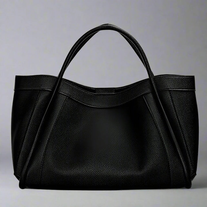 The Megyn Tote Bag is an East/West style featuring rolled top grab handles and seamed detail.