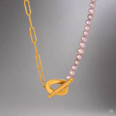 Paperclip and Pearl T Bar necklace in Gold with simulated freshwater pearls in a soft pink colour.