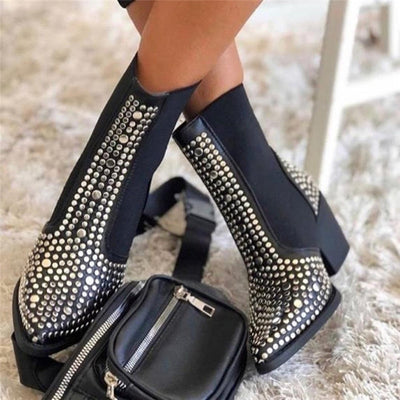 Standout rivet encrusted ankle boot featuring a fabric upper with stretch side gussets/panels, 5cm block heel, pointed toe and back pull on tabs.  