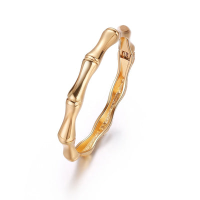The Bey is a hinged fashion bangle with a bamboo design.  Available in gold or silver plate over zinc alloy.