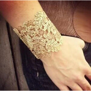 The Lacey cuff is both statement and delicate.  This gently adjustable piece is styled in a flower filigree pattern. Zinc alloy with gold plating. 