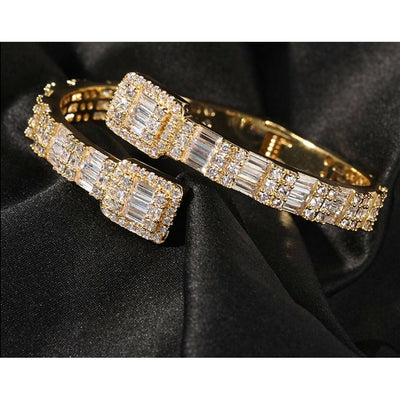 The Sloane is an Art Deco style wrap bracelet, featuring AAA Grade clear cubic ascher/princess cut zircons.  The base metal is brass and it is plated with 18k rose or yellow gold or rhodium (silver).  Hinged.  Length 7 inches.  