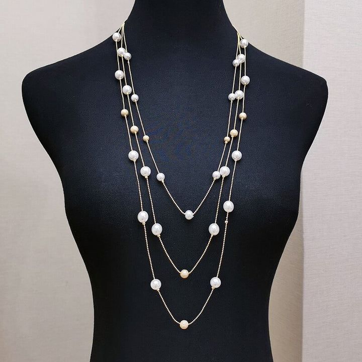 The Shelby is a statement multi strand station necklace featuring simulated pearls throughout, on a delicate zinc alloy gold wire. 45cm longest length. White pearl or gray (coloured). 