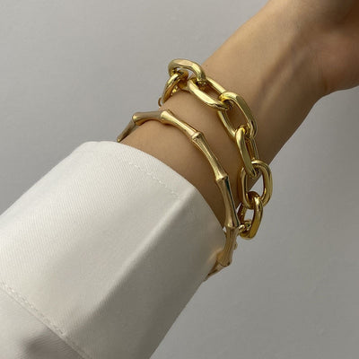 The Not so Basic Bamboo Bracelet Set features a bamboo styled bangle coupled with an oversized chain bracelet with 6cm extension chain and coin fob detail.  Zinc Alloy.  Gold or Silver.  Comes in luxury velvet jewellery pouch.