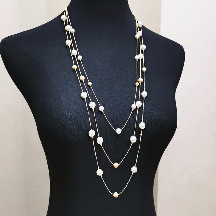 The Shelby is a statement multi strand station necklace featuring simulated pearls throughout, on a delicate zinc alloy gold wire. 45cm longest length. White pearl or gray (coloured). 