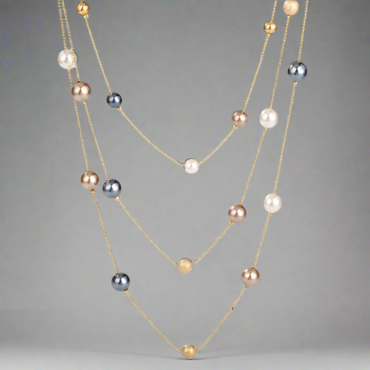 The Shelby is a statement multi strand station necklace featuring simulated pearls throughout, on a delicate zinc alloy gold wire. 45cm longest length. White pearl or gray (coloured). 
