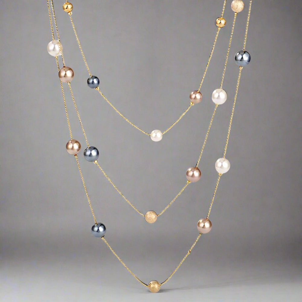 The Shelby is a statement multi strand station necklace featuring simulated pearls throughout, on a delicate zinc alloy gold wire. 45cm longest length. White pearl or gray (coloured). 